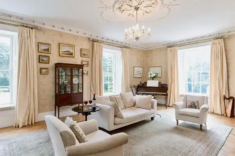 Spacious Georgian Villa living room with classic decor and large windows.