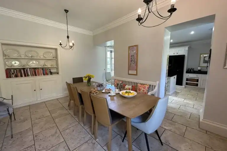 Bright dining room with wooden table and modern chairs in Georgian Villa.