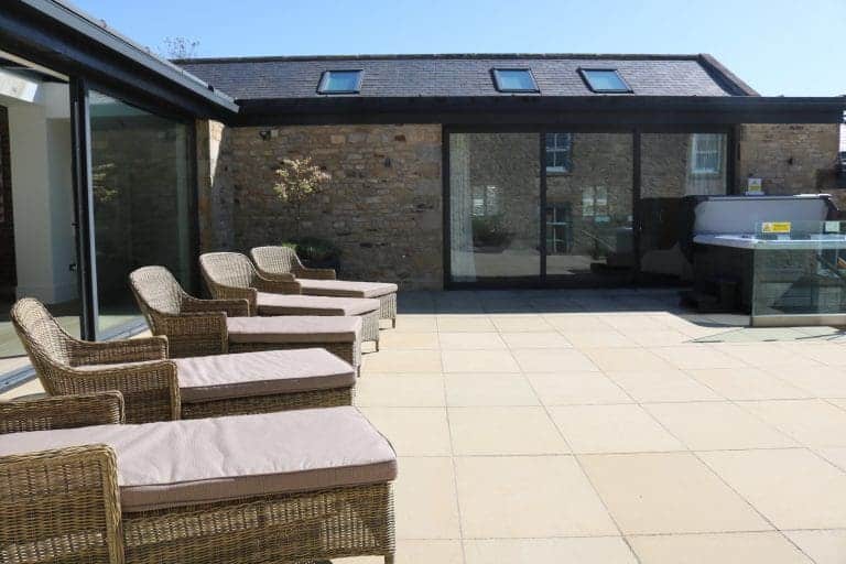 Rooftop terrace with wicker chairs and BBQ at Highleases Farm, Richmond.
