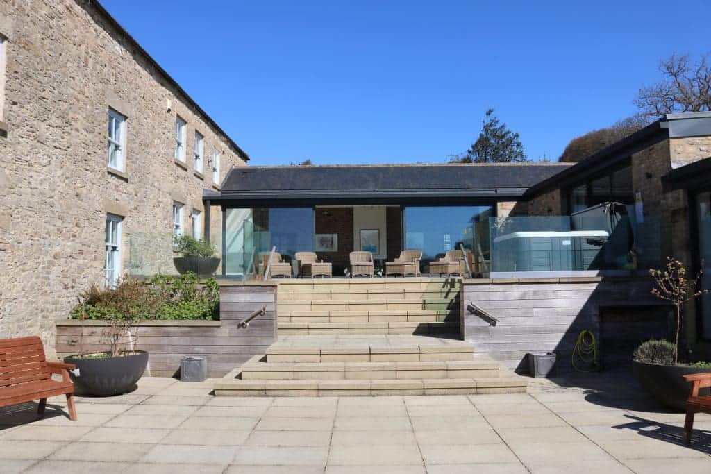 Contemporary glass extension with outdoor seating at Highleases Farm, Richmond.