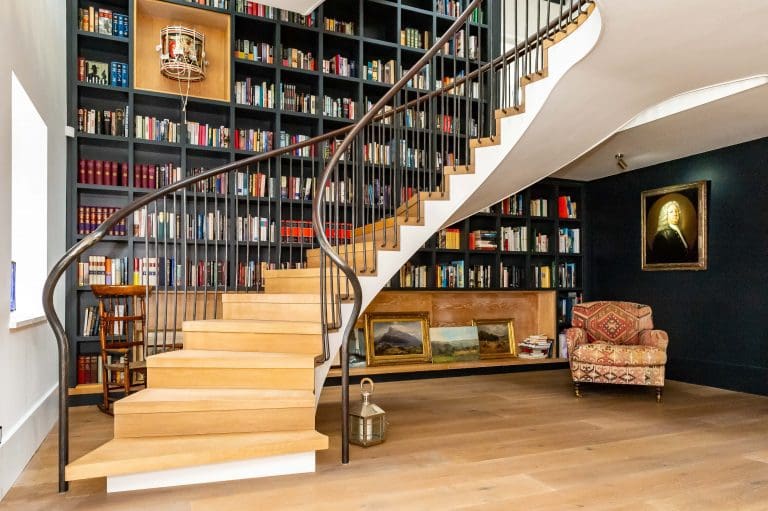 Large staircase with floor to ceiling bookshelf