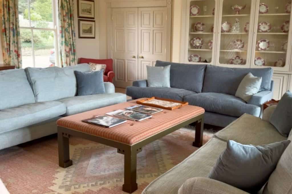 Comfortable sofas and a wooden coffee table in a traditional Yorkshire cottage.