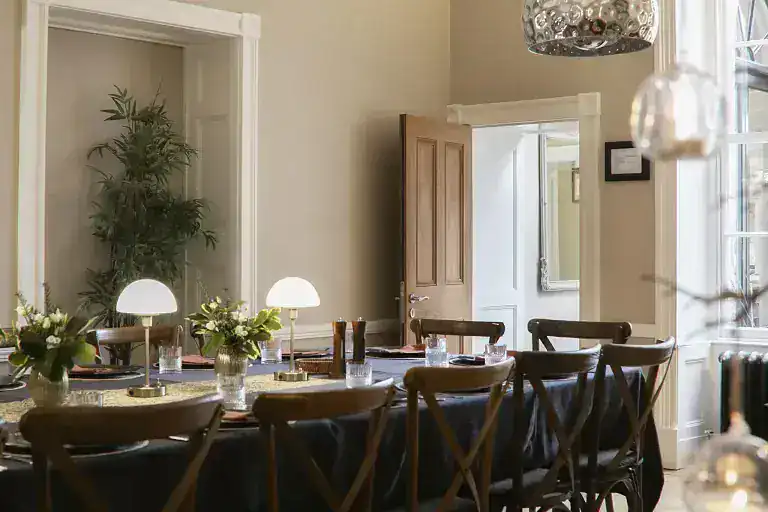 Stylish dining room with wooden table, chairs, and natural light at The Hall, Pateley Bridge.