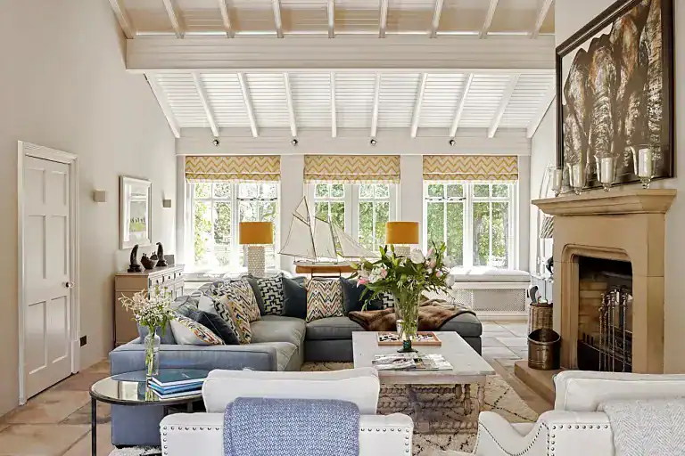 Bright and airy living room with large windows and cozy seating.
