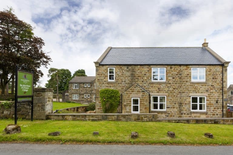 Traditional stone cottage near Ripon in Yorkshire with lush green surroundings.