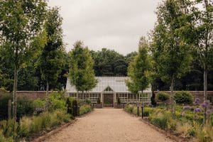 Beautiful garden pathway leading to a glasshouse near York.