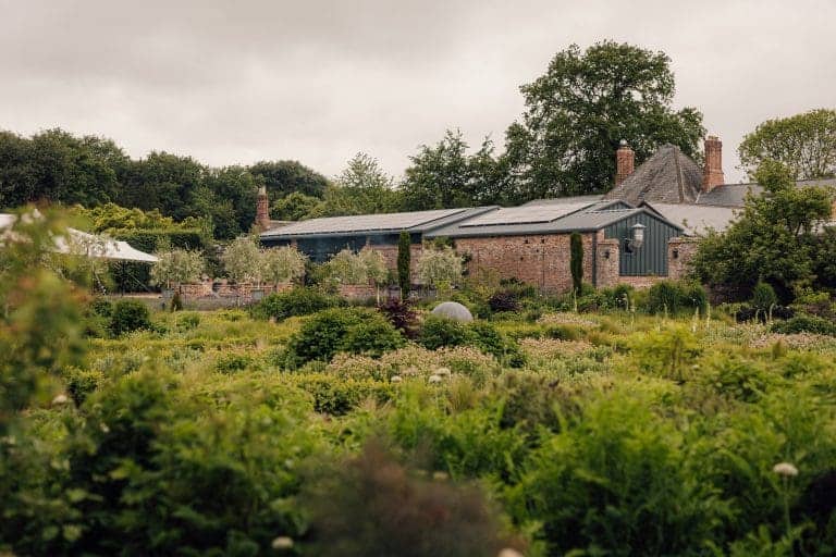 Rural garden with lush greenery and a traditional house near York.