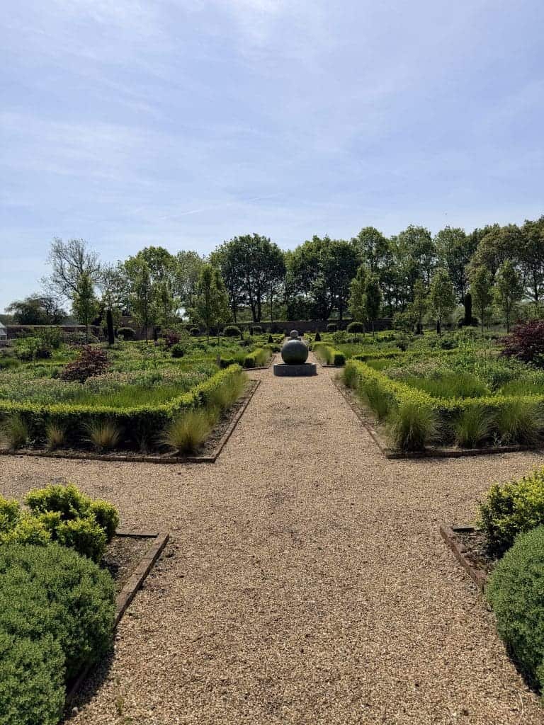 Serene garden with gravel path and decorative sphere in Yorkshire Escapes.