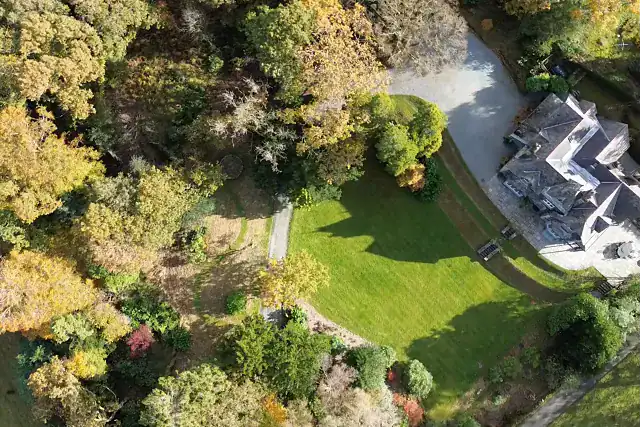 Aerial view of Birkdale House garden with lush greenery and surrounding trees in Windermere.