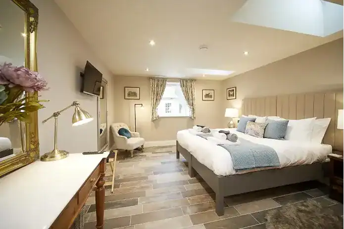 Elegant bedroom with a large bed, soft lighting, and classic decor near Driffield.