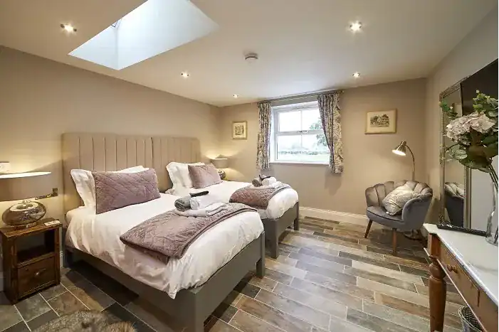 Comfortable bedroom with two beds, soft lighting, and elegant decor near Driffield.