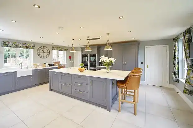 Spacious modern kitchen with grey cabinets and central island.