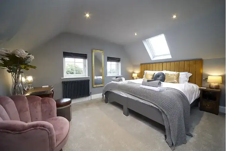 Cozy bedroom with skylight, double bed, and soft furnishings in Yorkshire Coast.