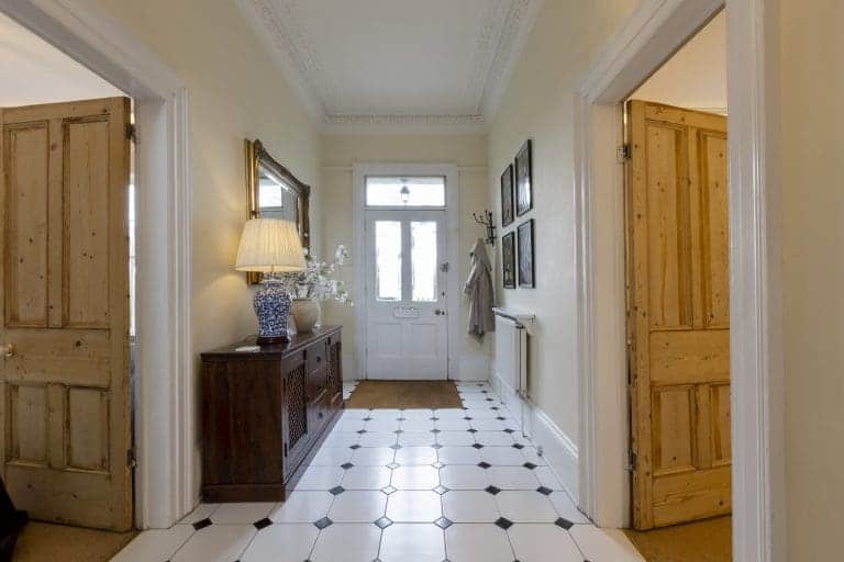 Elegant hallway in Granby House, Harrogate with classic decor and black and white tiled floor.