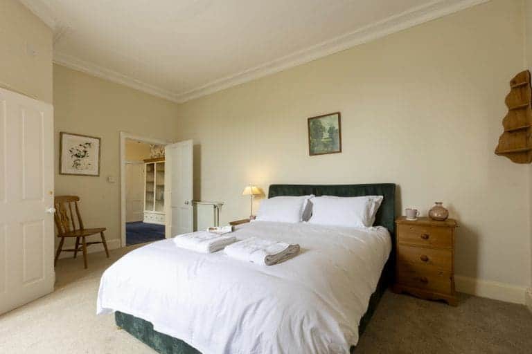 Cozy bedroom at Granby House, Harrogate with a large bed and classic decor.