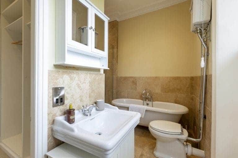 Modern bathroom with bathtub, sink, and toilet in Granby House, Harrogate.