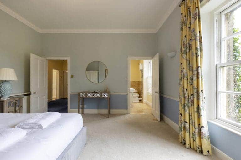 Spacious bedroom at Granby House, Harrogate with large window and elegant decor.