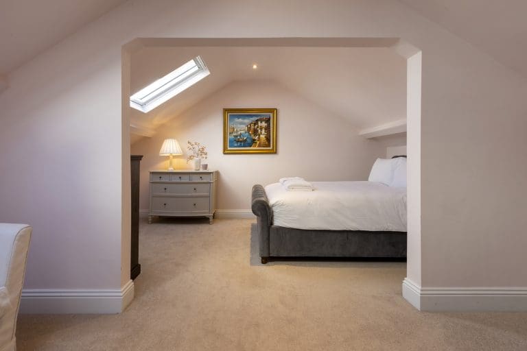 Spacious bedroom in Granby House, Harrogate with a skylight and elegant decor.