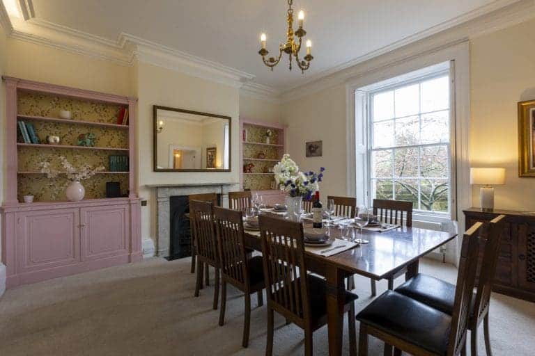 Elegant dining room at Granby House, Harrogate with a large wooden table and classic decor.