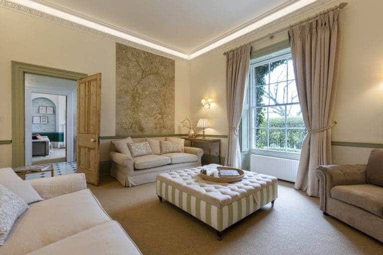 Elegant living room in Granby House, Harrogate with classic furnishings and large windows.