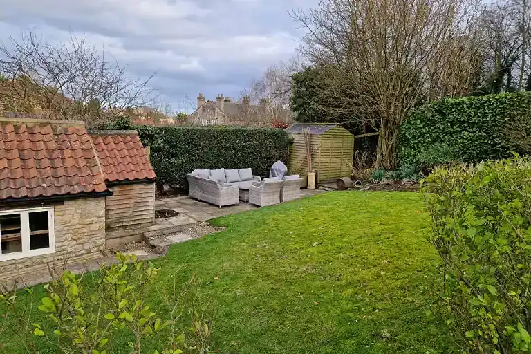 Garden view at Foxglove Cottage with outdoor seating and lush greenery.