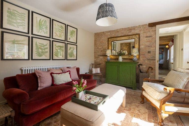 Cozy living room with vintage furniture and botanical wall art in Yorkshire Escapes.