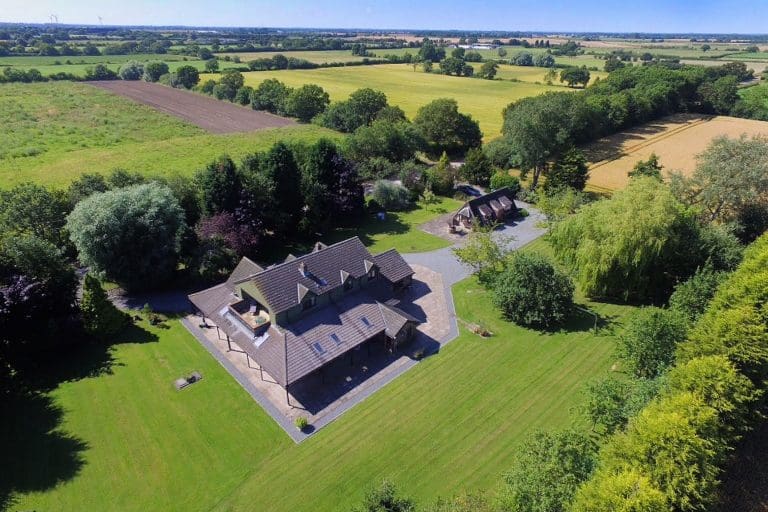 Aerial view of Cedar House surrounded by lush greenery in East Yorkshire.