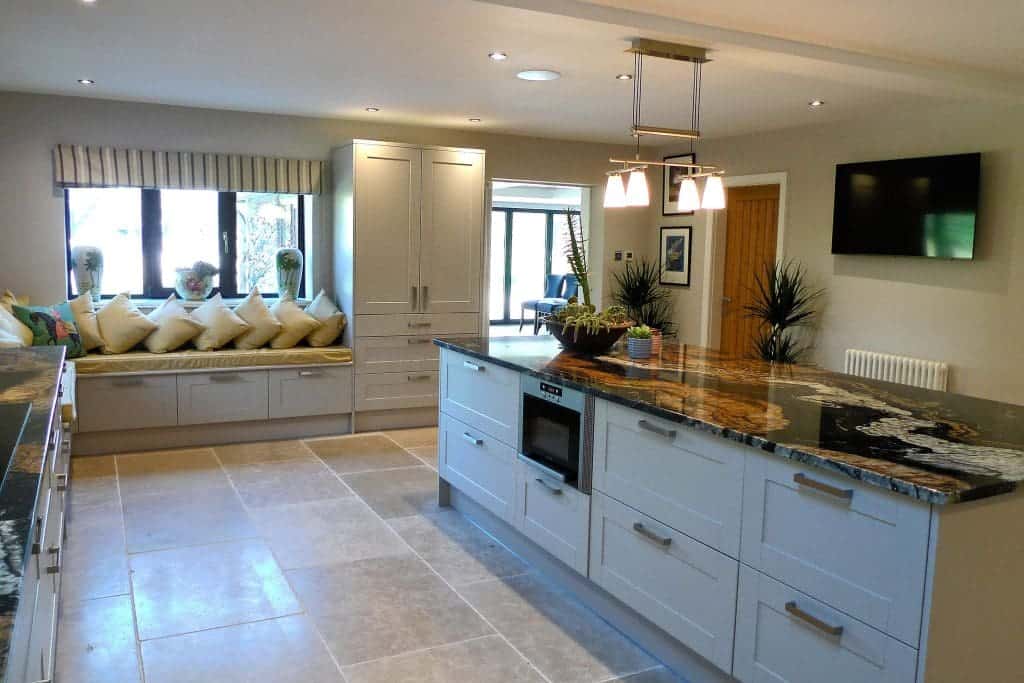 Modern kitchen at Cedar House, East Yorkshire with large window and island.