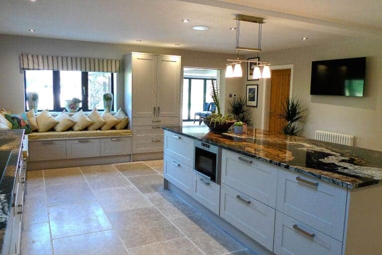Modern kitchen at Cedar House, East Yorkshire with large window and island.