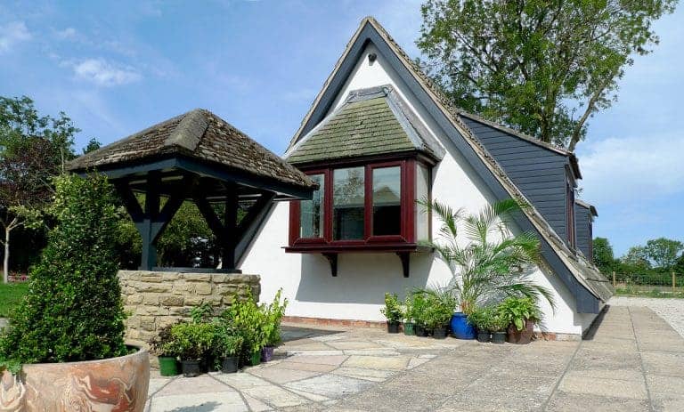 A distinctive A-frame house with white walls and dark roof in East Yorkshire.