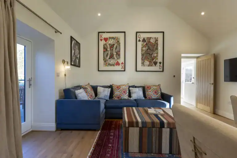 Cozy living room with blue sofa and colourful cushions in Yorkshire escape.