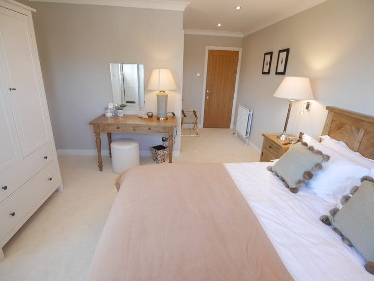 Cozy bedroom with wooden furniture and soft lighting in Cedar House, East Yorkshire.
