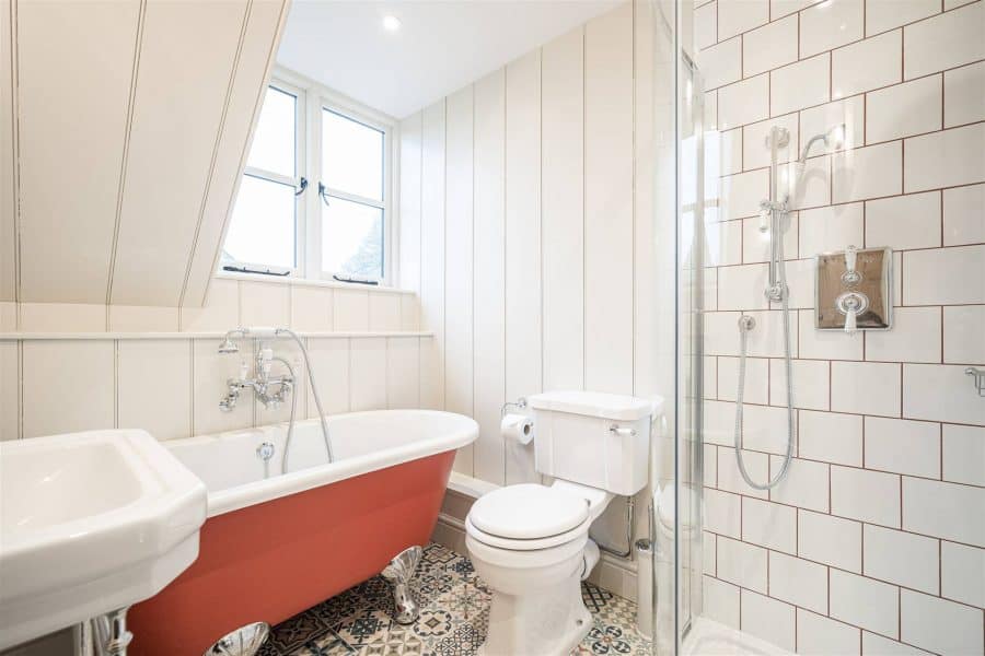 Charming bathroom with vintage bathtub and modern shower in Yorkshire escape.