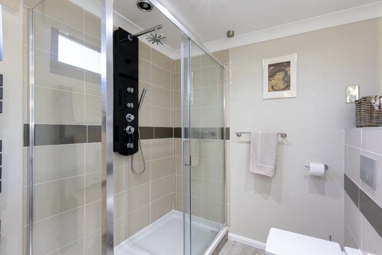 Modern walk-in shower with glass enclosure in a contemporary bathroom.