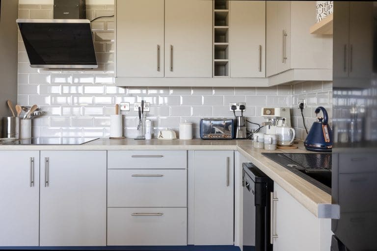 Modern white kitchen with sleek cabinets and appliances in Yorkshire Escapes property.