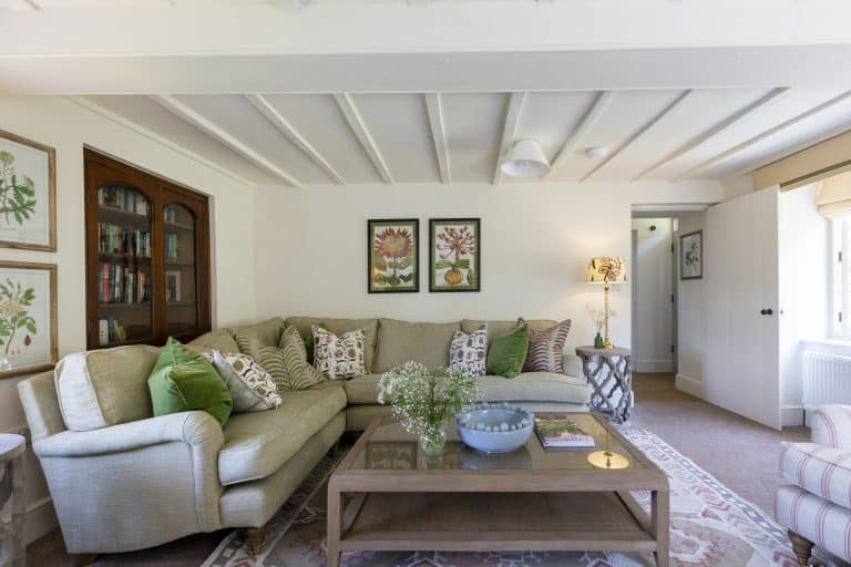 Cozy living room with beige sofa and green cushions in Abbey Cottage, Rievaulx.