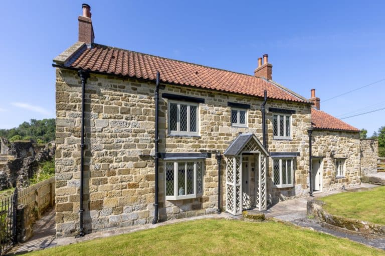 Historic stone cottage near Rievaulx with traditional windows and red tiled roof.