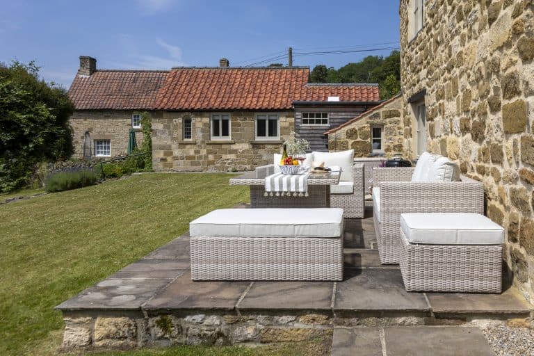 Outdoor patio with wicker furniture at Abbey Cottage, Rievaulx near Helmsley.