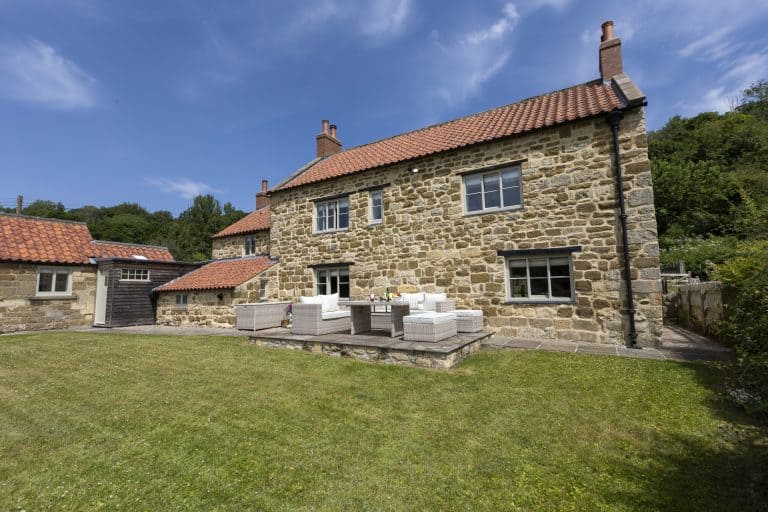 Abbey Cottage in Rievaulx with stone walls and a red-tiled roof.