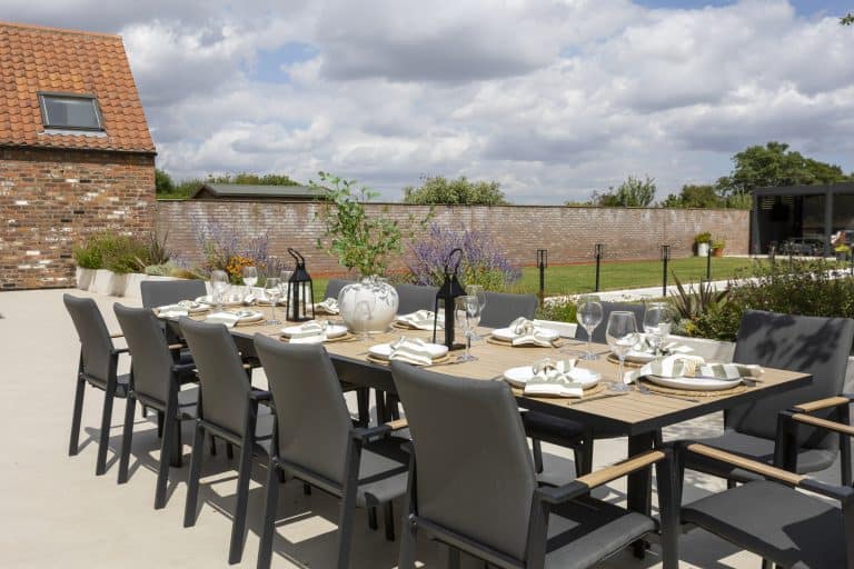 Elegant outdoor dining area with a long table set for a meal near York.