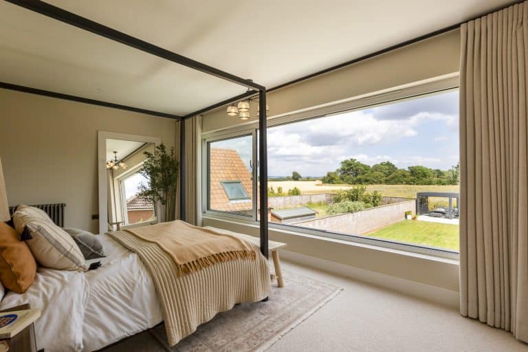 Bright bedroom with large window overlooking Yorkshire countryside.